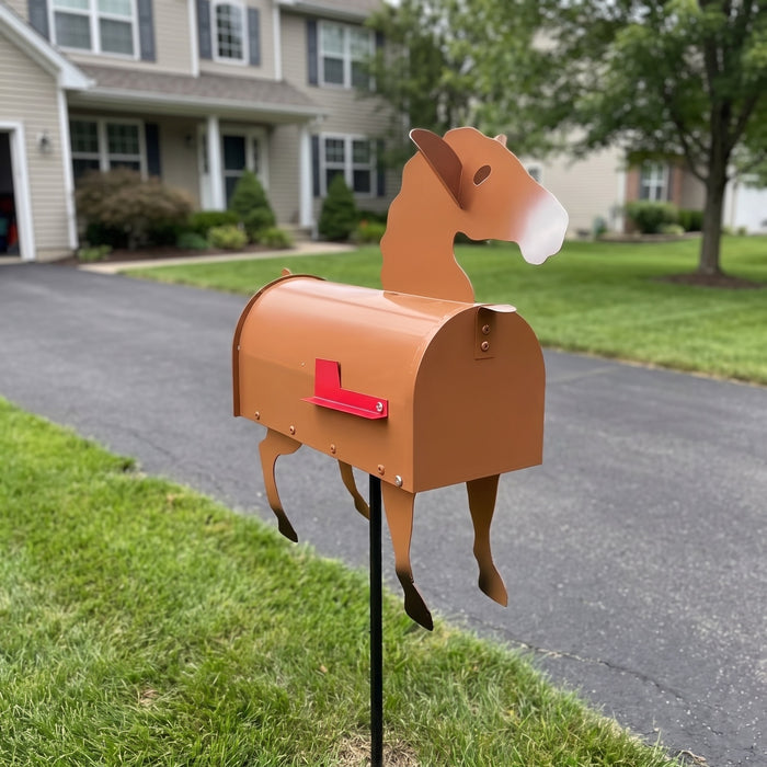 Tan horse mailbox on a ground stake at a driveway