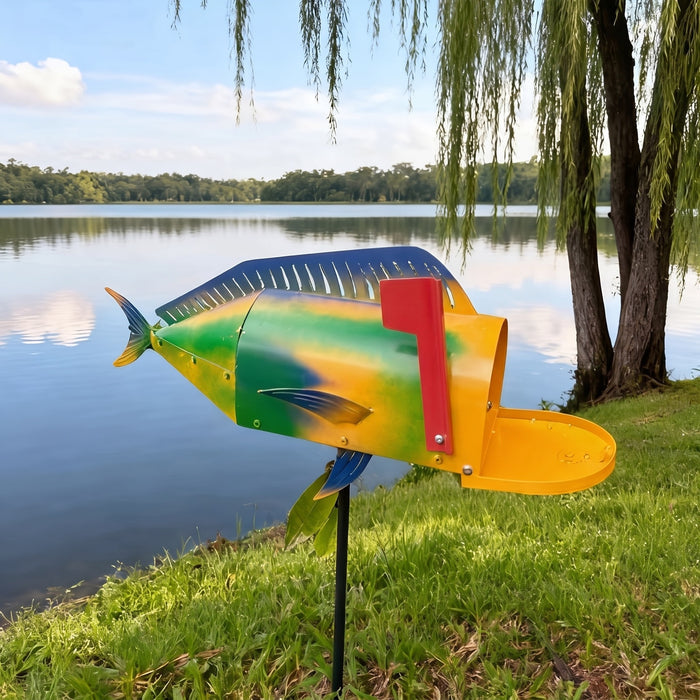 Mahi-mahi fish mailbox on a ground stake by a lake